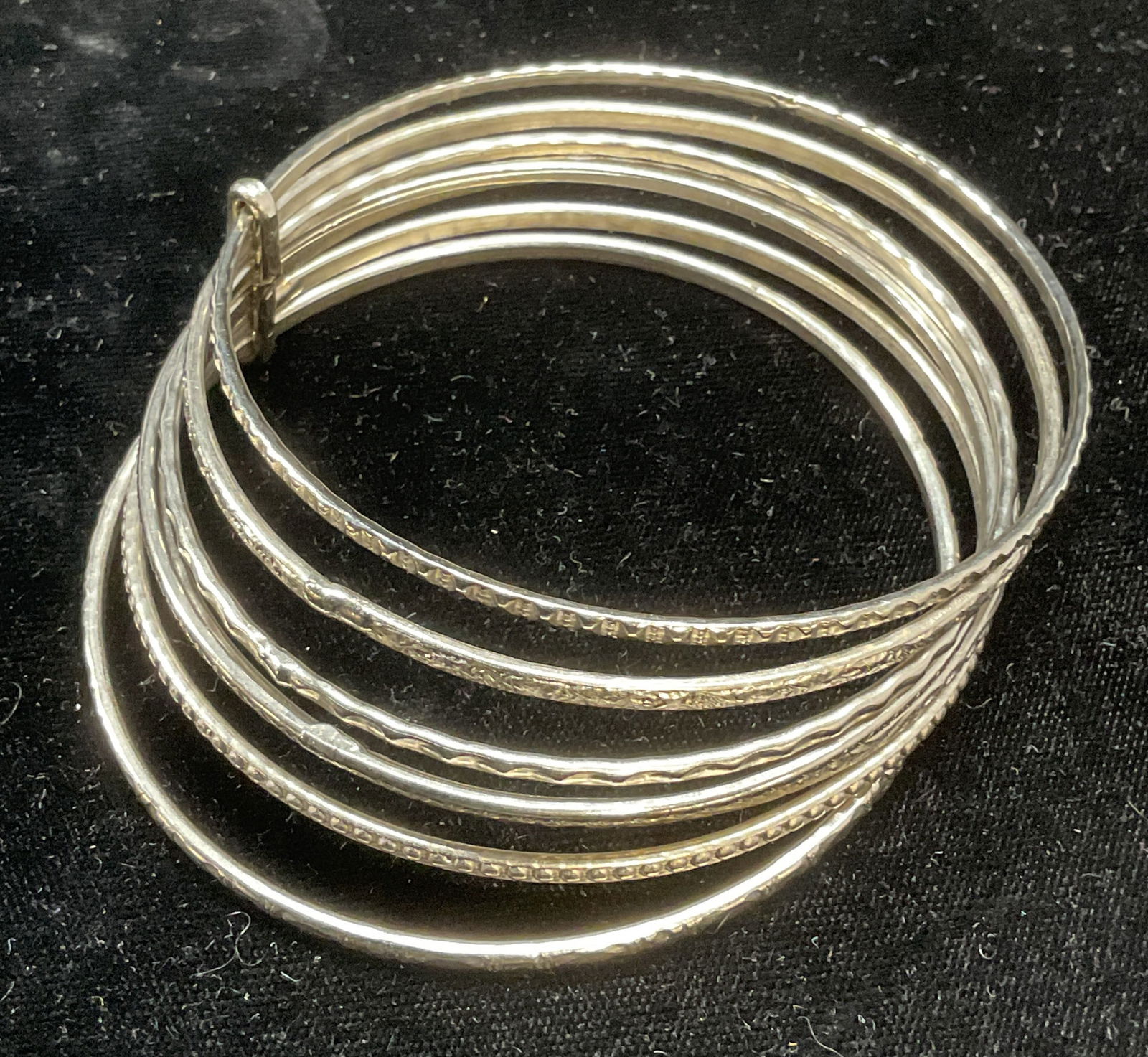 Vintage Silver Tone Stacked Bangle Bracelet: Vintage silver tone stacked bangle bracelet with textured bands. Measures approx 3 inches wide. Some wear including scratching observed. Jewelry, estate jewelry, costume jewelry, fashion jewelry, cock