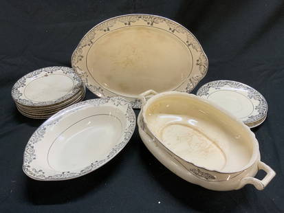 TST CO Partial Porc Dish Set 12: Underside reads TST CO. Lot includes 2 saucers, 1 oval serving dish, 1 oval serving bowl, 1 oval serving bowl with handles, & 7 bread plates. Each are cream with silver toned floral detailed edges. La