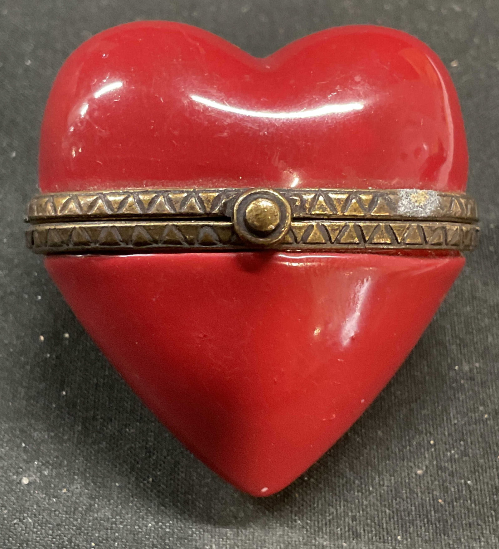 Vintage Red Porcelain Heart Trinket Box: Vintage red porcelain heart motif trinket box with raised brass rim. Measures approx 2 x 1.75 inches. Some scratching. Trinket box, porcelain trinket box, heart trinket box, home decor, home accessori