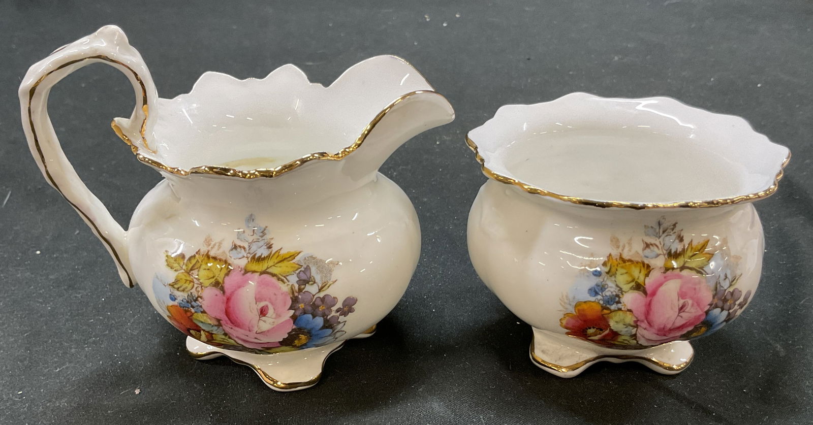 Set2 AYNSLEY Bone China Creamer Sugar Bowl England: Set 2 AYNSLEY bone china creamer and sugar bowl. Pink cabbage rose pattern design. Footed with Gold rim detailings. Sugar bowl measures 3 x 2.25 inches. Made in England. Some surface wear consistent w