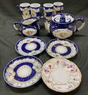 Lot 10 Antiq Nippon Porcelain Demitasse Tea Set: Lot 10 Antiq Nippon porcelain demitasse tea set. Lot includes 4 saucers, 1 creamer, 1 tea pot with lid, 4 cups. Cobalt blue band with gold lattice overlay. Hand painted colorful floral motifs. Framed