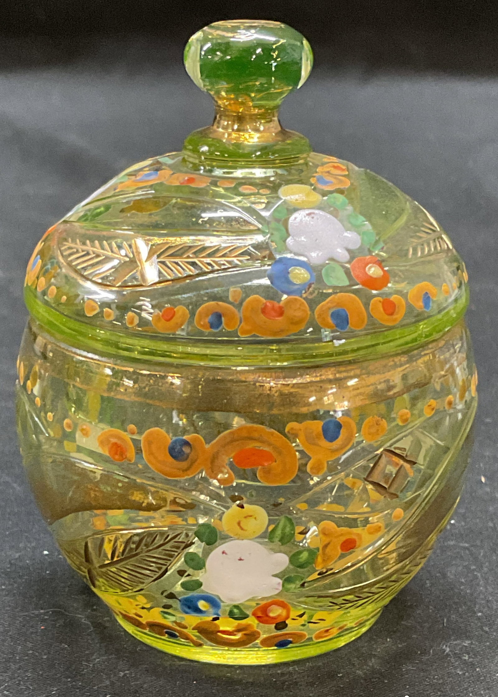 Hand Painted Gilt Yellow Art Glass Lidded Jar: Yellow art glass jar with lid. Hand painted with floral design and gilt accents. Measures approx 2.75 x 3.5 inches including lid. Some scratching and loss to paint. Art glass, art glass jar, lidded ja