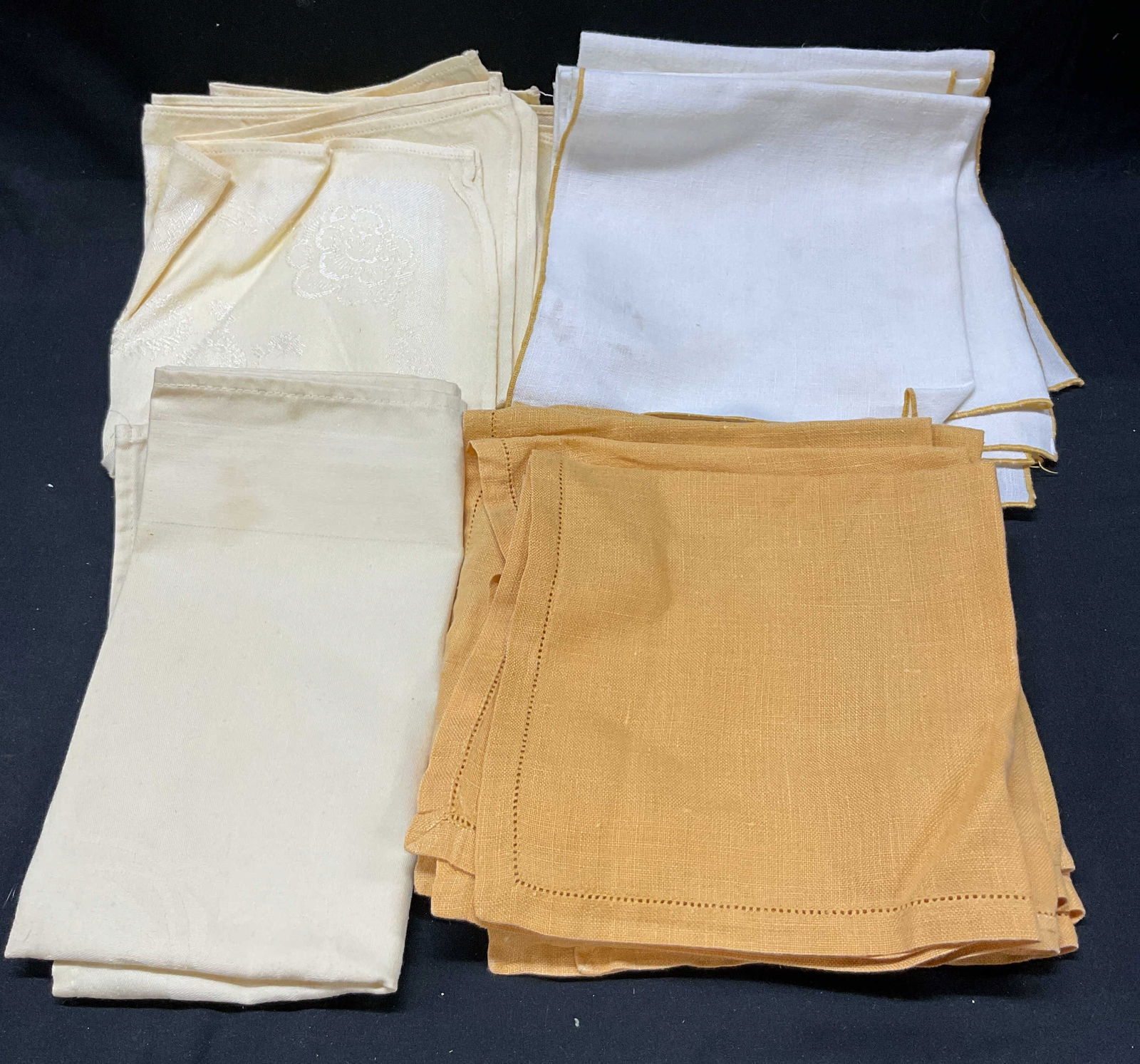 Lot 21 Cream Orange Cotton Table Linens: Lot 21 cream orange cotton table linens. Cream and orange solid color design. One napkin reads The Ritz-Carlton material appears to be cotton. Largest napkin measures 19.25 inches. Some staining and d