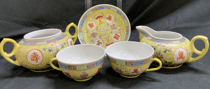 Lot 5+ Yellow Floral Chinese Porcelain Tea Set: Lot 5+ Yellow Floral Chinese Porcelain Tea Set Tea set is yellow & adorned with various symbols & floral scrolls. Lot includes 1 sugar & 1 creamer set, 2 cups & 1 saucer. Signed & marked on underside.