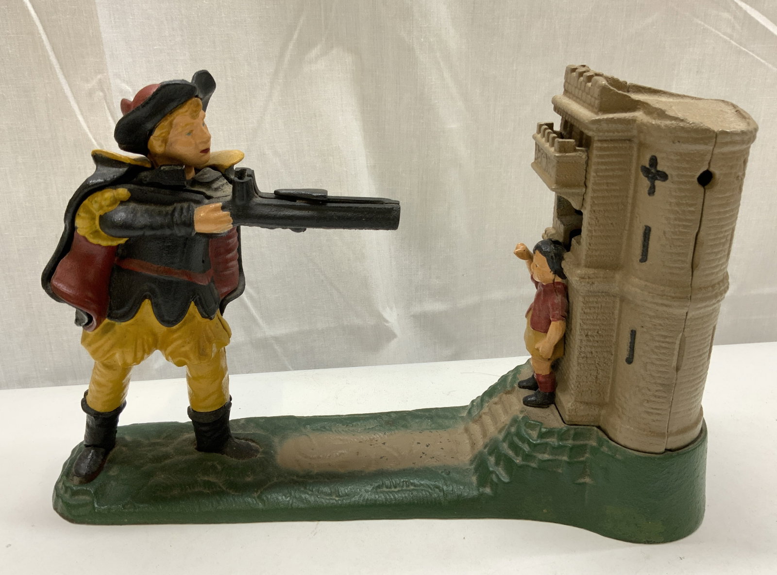 William Tell Shooting Mechanical Cast Iron Bank: William Tell Shooting Mechanical Cast Iron BankMechanical bank featuring a figurine in military attire holding a gun. Not tested for function. Signed & marked on underside. Reads Reproduced from origi