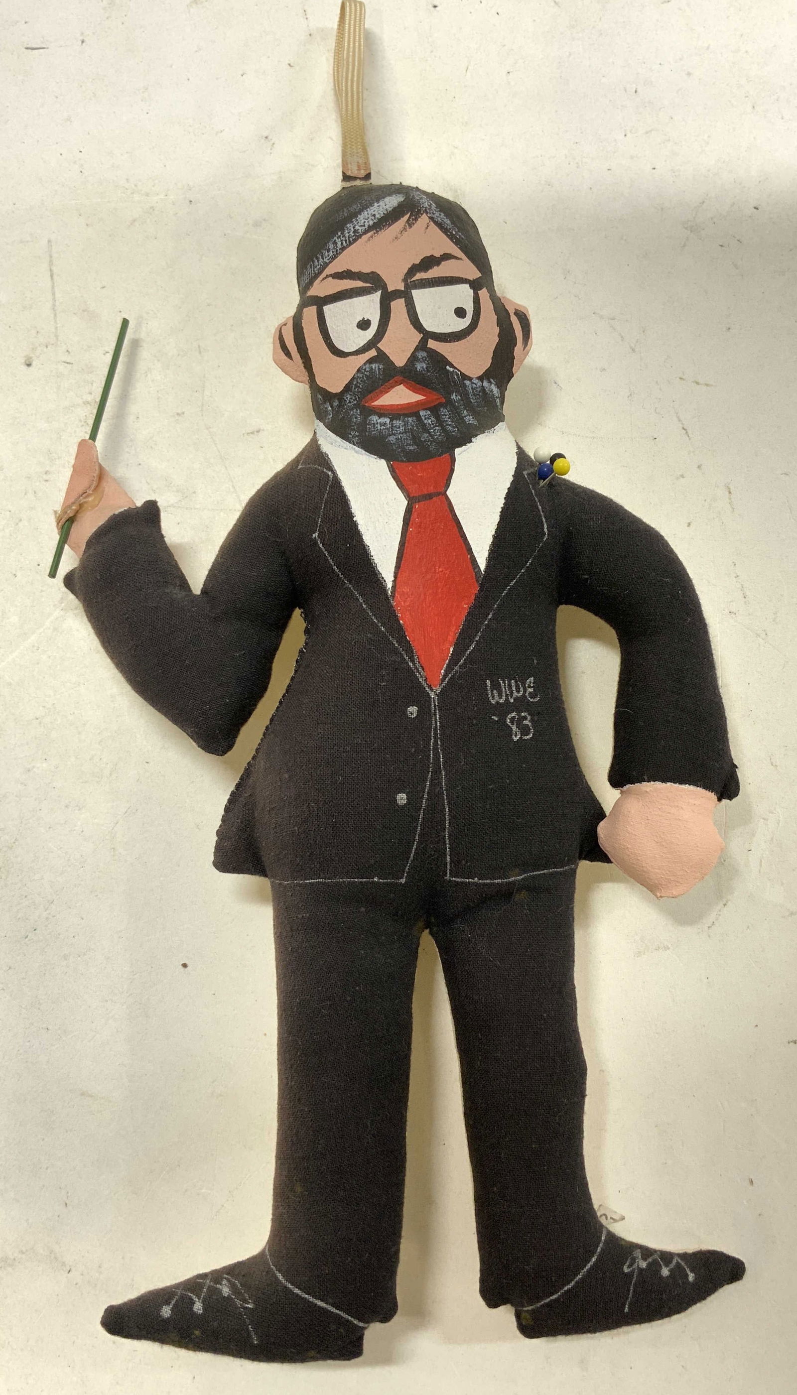 WWE 83 Hand Painted Fabric Plush Doll: WWE 83 Hand Painted Fabric Plush Doll Plush doll depicting a figure dressed in a suit with a red tie & glasses. Figure is hand-painted & features needles. Plush doll reads WWE 83. Signed & marked. Sur