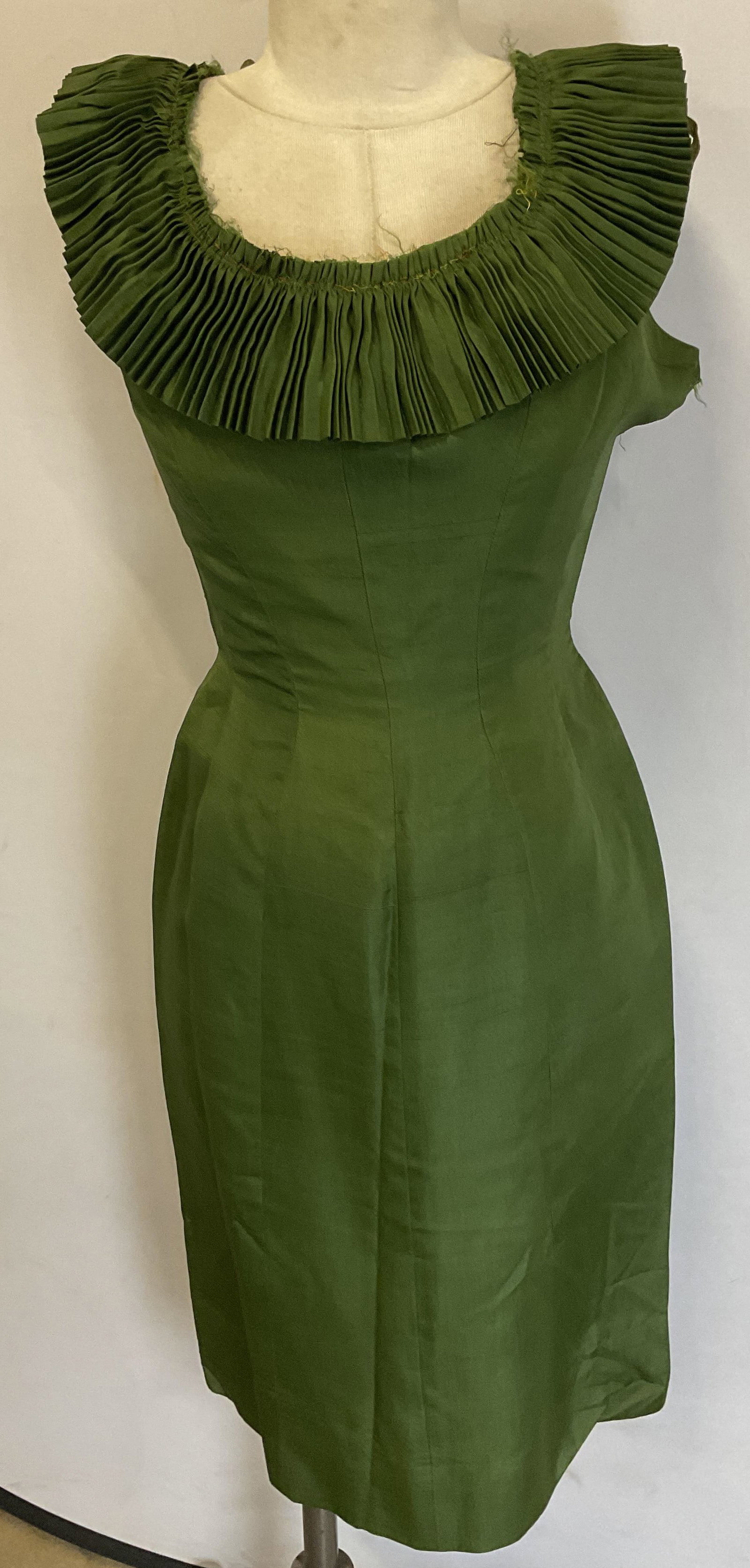 Vintage Green Silk Ruffle Collar Dress: Vintage green sleeveless dress with pleated ruffle collar. Feels like silk. Measures approx 16 inches across chest, 12 inches across waist. Wear including blemishes, tearing, collar needs repair. Dres