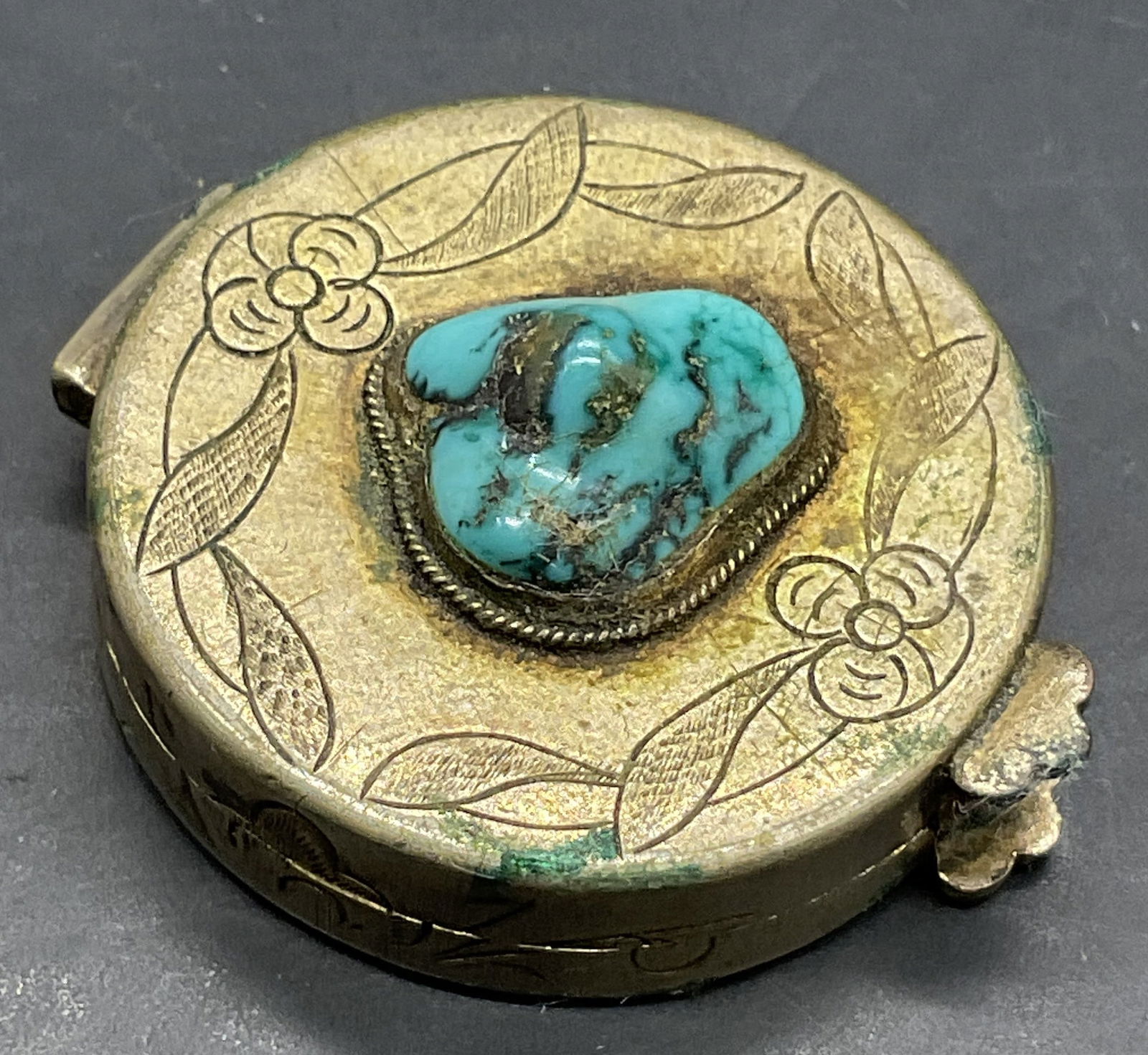 Vintage Turquoise Tn Natural Stone Metal Pill Box: Vintage Turquoise Toned Natural Stone and Metal Pill Box. Etched silver tone metal pill box opens with hinge hardware and features a bezel set natural stone to the lid. Measures approx. .5H x 1.25W in