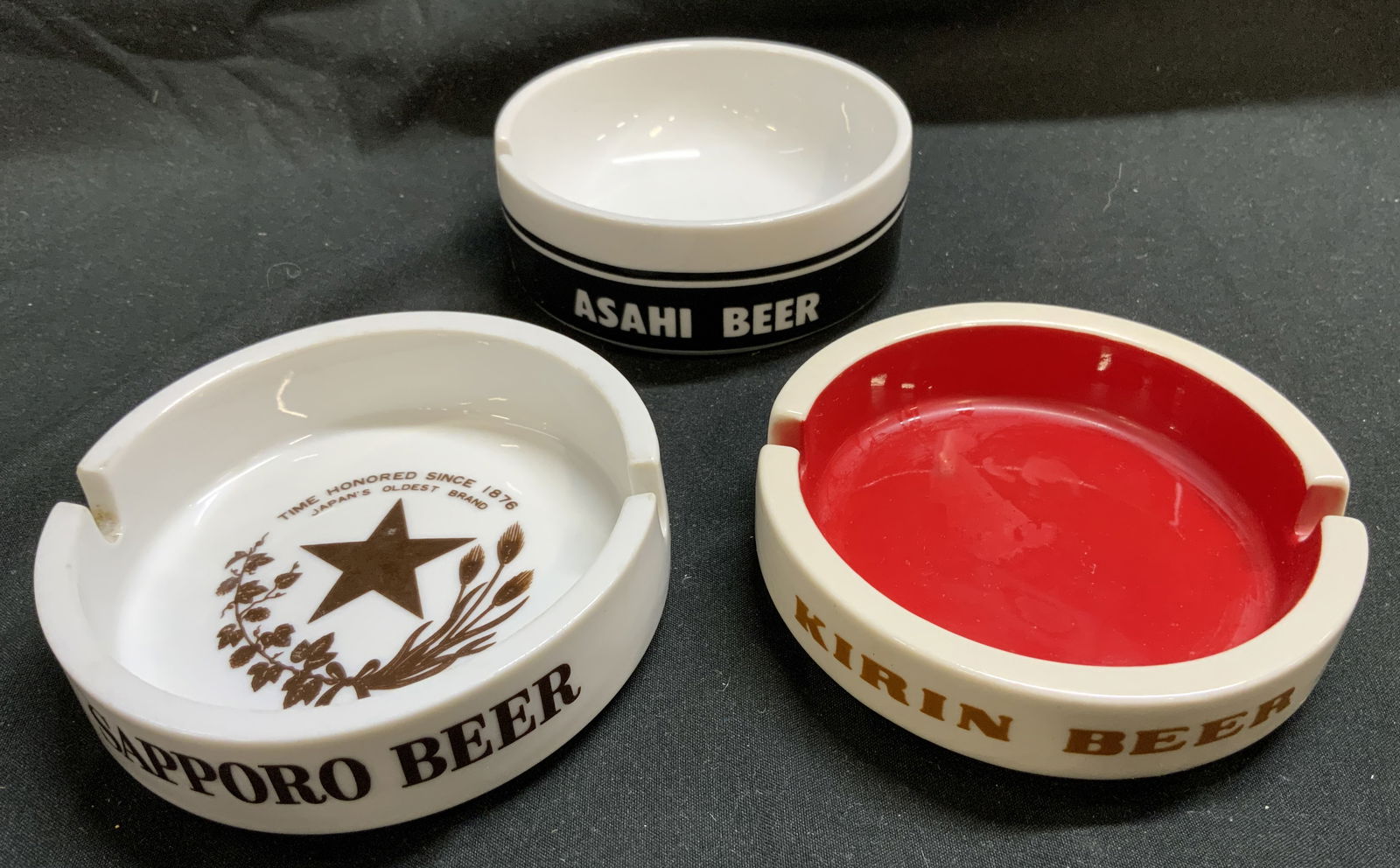 Lot 3+ Assorted Porcelain Souvenir Ashtrays JAPAN: Lot 3+ Assorted Porcelain Souvenir Ashtrays JAPAN 3 porcelain souvenir ashtrays from Kirin Beer, Sapporo Beer & Hoya. All made in JAPAN. Surface wear consistent to age, use & exposure. Measurements: l