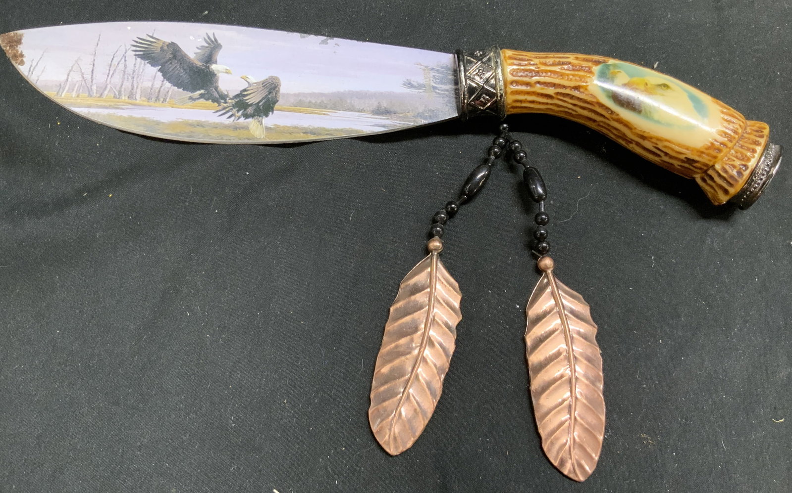 Vtg Indian Art Knife W Bone Handle & Eagle Detail: Box reads INDIAN ART KNIFE. Knife is vintage. Piece has tan toned carved bone handle with depiction of bald eagles. Blade inscribed stainless with depiction of bald eagles fighting. Knife has beaded a