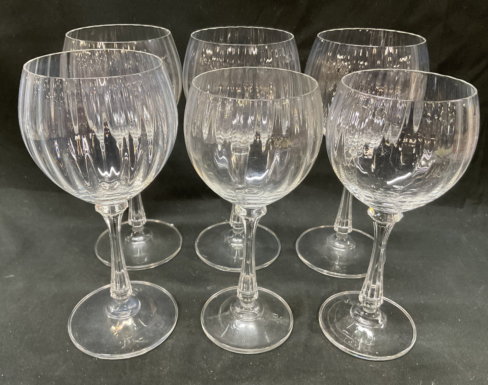 Set 6 MIKASA Crystal Wine Water Glasses: Set 6 MIKASA crystal wine water glasses. Crystal clear optic ribbed bowl with clear faceted stem and clear base. Largest glass measures 7.5 x 3.5 inches. Some surface wear consistent with exposure. MI
