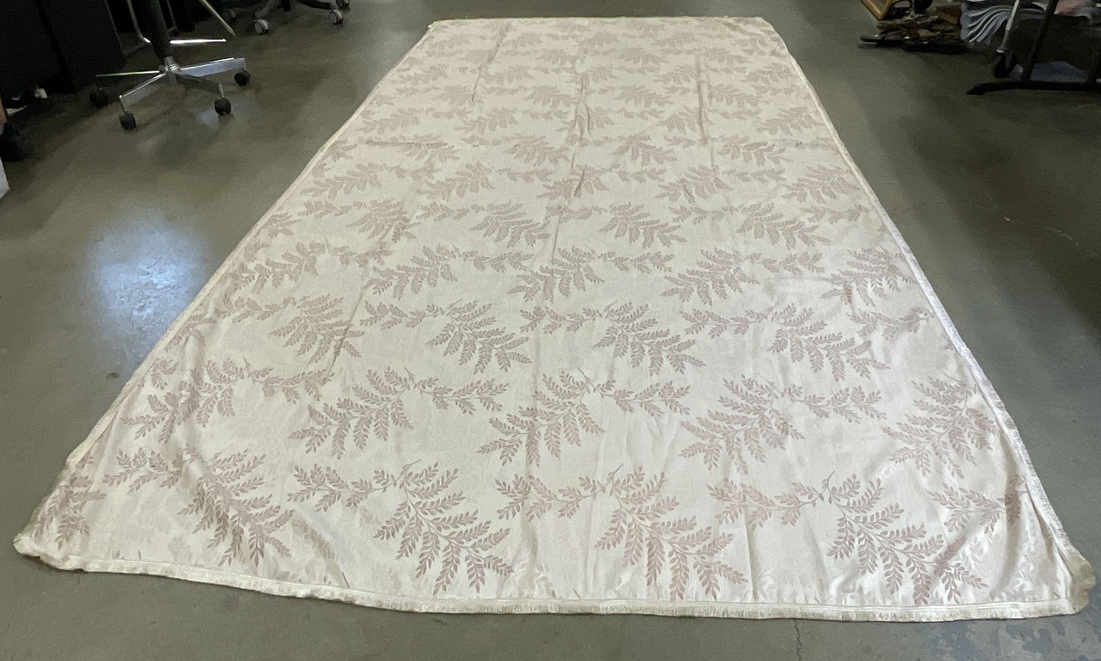 Cotton Blend Pink Tn Botanical Pattern Tablecloth: Cotton Blend Pink Toned Botanical Pattern Tablecloth. Fringe trim. Rectangular form. Material tag reads Cotton & Polyester. Measures approx. 67W x 139L in. Discoloration, surface wear, and residue pre