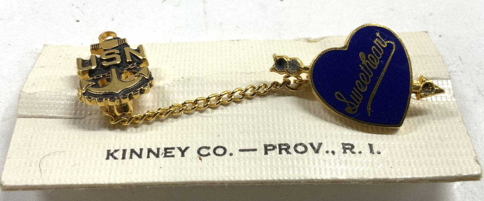 USN SWEETHEART Gilt & Enamel Dangling Pin 1966: Paper reads Kinney Co. - Prov., Ri. Providence, Rhode Island. Pin is gilt and enamel. One reads USN and has anchor form. One reads SWEETHEART, Backside reads TO LINDA ALL MY LOVE RICKY 66. 1966 Pins m