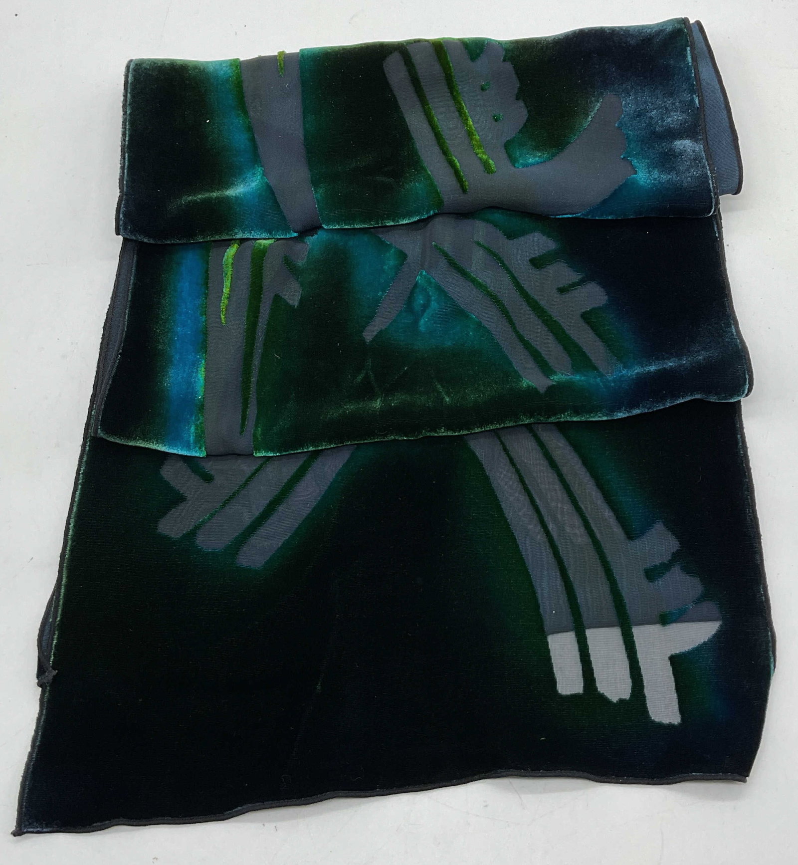 Vtg Green Blue Velvet Sheer Scarf: Vintage green blue velvet sheer scarf. Blue and green ombre design. Geometric slash pattern designs. 11 inches wide. Some surface wear consistent with exposure. Green scarf, velvet scarf, blue scarf, 