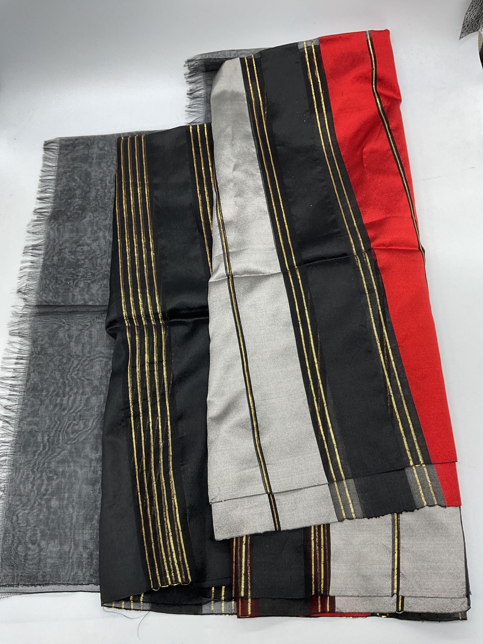 Vtg Black Red Gold Accent Silk Shawl Scarf: Vintage black red gold accent shawl scarf. Black, red, light grey block stripes with gold striped accents. Material appears to be silk. 40 inches wide. Some surface wear consistent with exposure. Blac