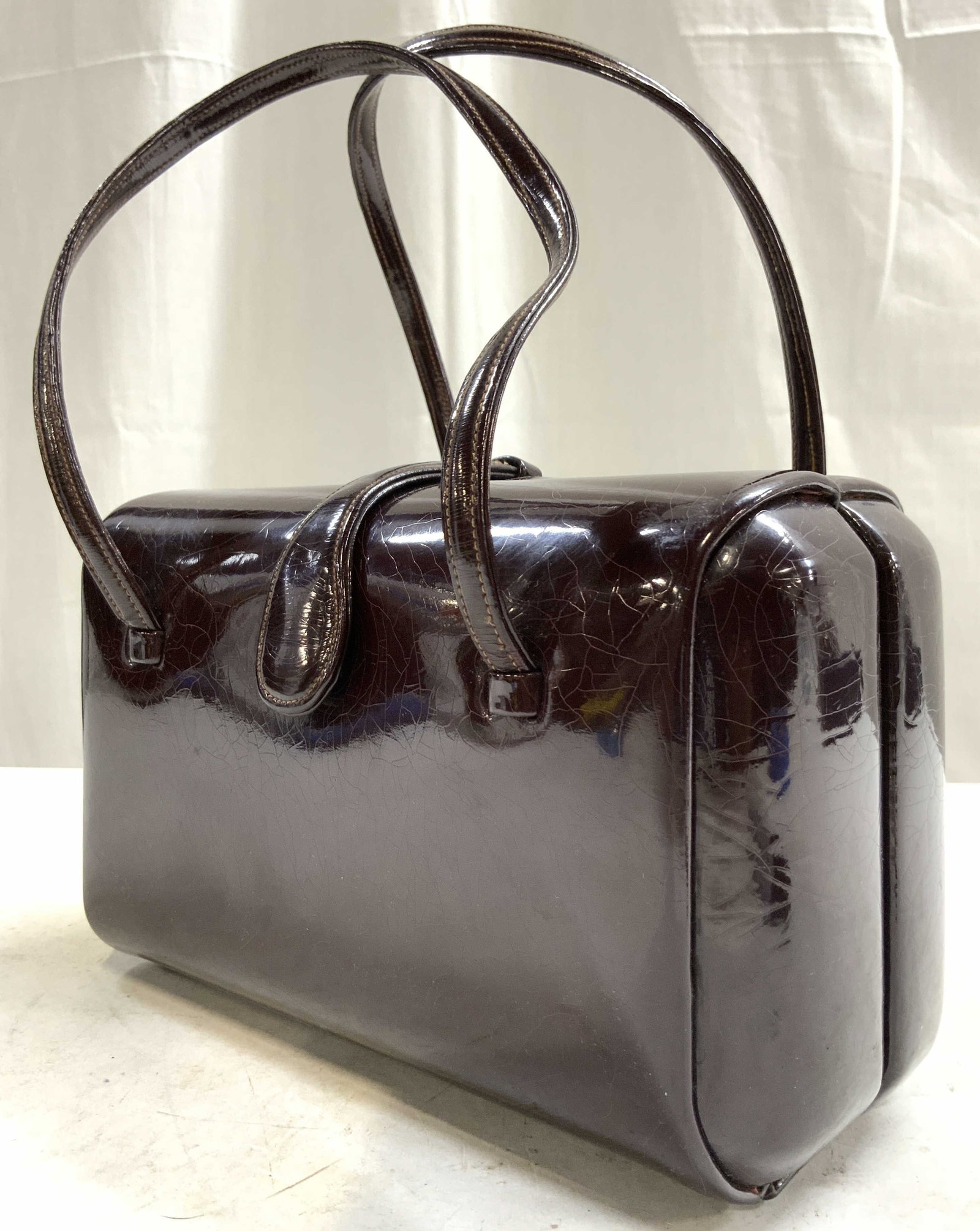 PRESTIGE Burgundy Patent Leather Womens Bag: Interior is trademarked PRESTIGE. Bag is burgundy toned patent leather. Bag folds and has snap button clasp. Possibly vintage. Interior is brown toned with 3 pockets. Bag measures approximately 8 inch