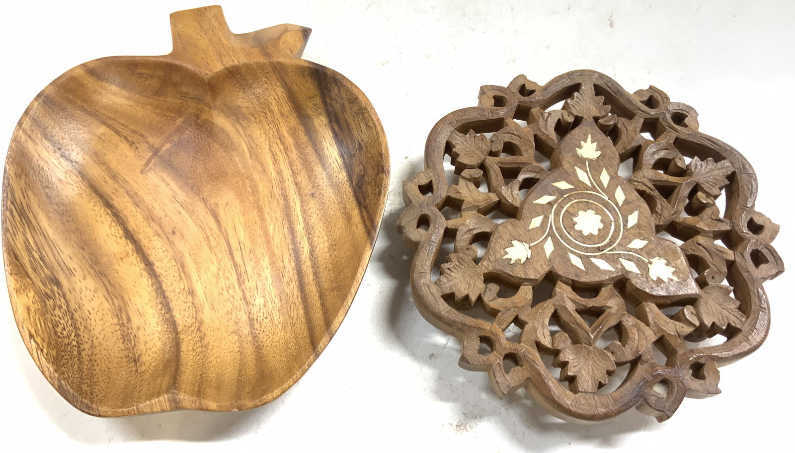 Lot 2 Wooden Apple dish & Moorish Trivet: Lot includes 1 apple form dish. Piece is tan toned and wooden. Lot also includes light brown toned carved wooden Moorish trivet with 3 feet and bone inlay vine and leaf detail. Apple form dish measure