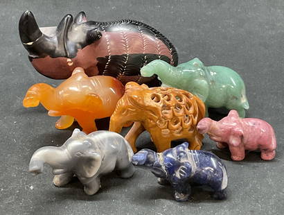 Lot 7 Jade Wood Elephant Rhinoceros Mini Figurines: Lot 7 jade wood elephant rhinoceros mini figurines. Hand carved 6 elephants and 1 rhinoceros. Various materials including jade, stone and wood. Text underneath rhinoceros reads from the great rift val