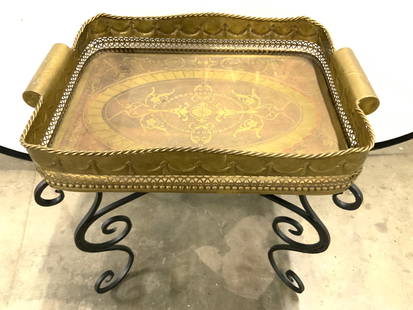 CASTILIAN Vtg Iron & Brs Ornate Tray Tbl: Tag on underside reads CASTILIAN. Table top tray is gilt metal, appears to be brass. Tray has gallery edges with pierced detail. Piece has corded rim. Sides of tray have handles. Piece has black toned