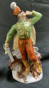 HEREND Dragon Slayer Porcelain Figurine HUNGARY: HEREND Dragon Slayer Porcelain Figurine HUNGARYHand-painted porcelain figurine depicting a hussar soldier in military attire with a sword in his right hand & standing over a dragon. Figure has gold ac