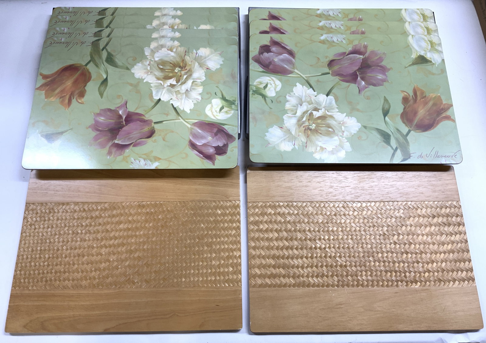 CLOVERLEAF & TABLEAUX Lot 9 Placemats W Bxs: Lot includes 2 tan toned wooden placemats inscribed CLOVERLEAF on underside & 7 placemats with multi toned floral detail with boxes. Boxes trademarked TABLEAUX. Floral placemats read F DE VILLANUEVE. 