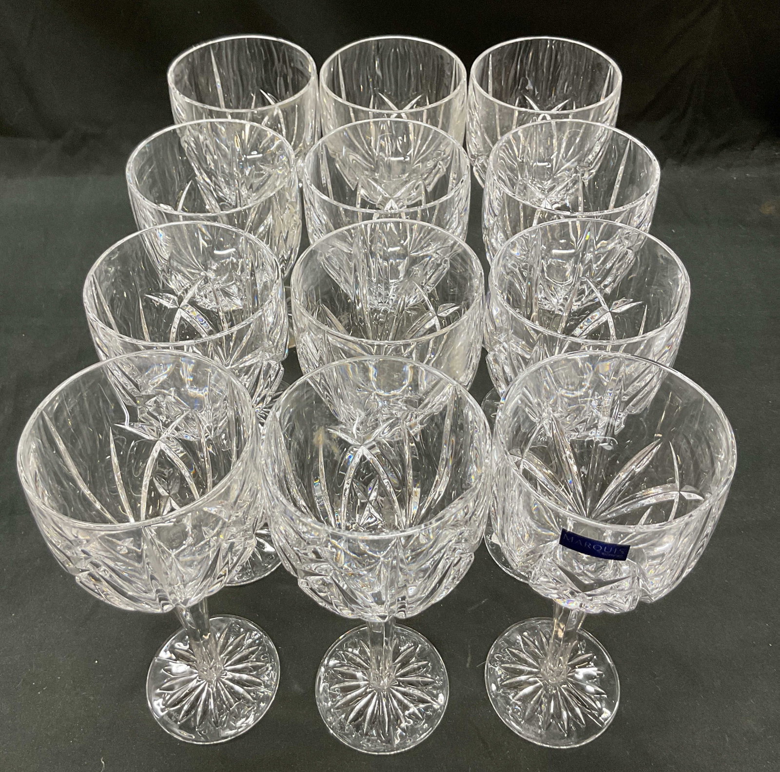 Set 12 Marquis by Waterford Crystal Wine Glasses: Set 12 Marquis by Waterford Crystal wine glasses. BROOKSIDE All purpose pair crystal glasses. Cut glass, no trim. Signed on underside. 8.5 x 3.5 inches. Some surface wear consistent with exposure. Mar