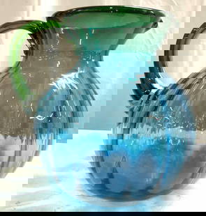 Blenko Scalloped Hand Blown Art Glass Pitcher: Pitcher appears to be BLENKO (NO apparent markings). Pitcher is blue with toned rim. Vessel appears to be hand blown due to pontil on underside. Pitcher is scalloped. Piece measures approximately 9 in