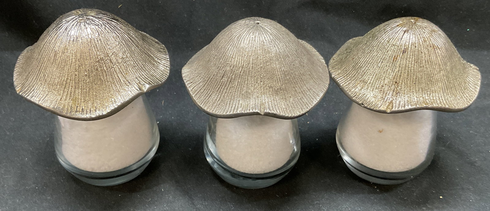 Set 3 Glass Metal Mushroom Salt and Pepper Shakers: Set 3 glass metal mushroom salt and pepper shakers. Mushroom cap made in metal with glass body. 3 x 1.5 inches. Some surface wear consistent with exposure. Glass salt and pepper shakers, Salt and pepp