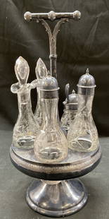 1890s Antique Rotating Condiment Cruet Silverplate: 1890s antique rotating condiment cruet silverplate. Etched floral designs. Glass bottle cruet set oil vinegar. 15.5 x 7.5 inches. Some surface wear to silver plate, one glass bottle broken. Rotating c
