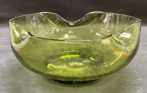 Vintage Green Art Glass Curved Serving Bowl: Vintage emerald green art glass serving bowl with curved rim design. Thick walled glass, piece is heavy. Style of Anchor Hocking, unmarked. Measures approx 9 x 4 inches. Some scratching observed. Art