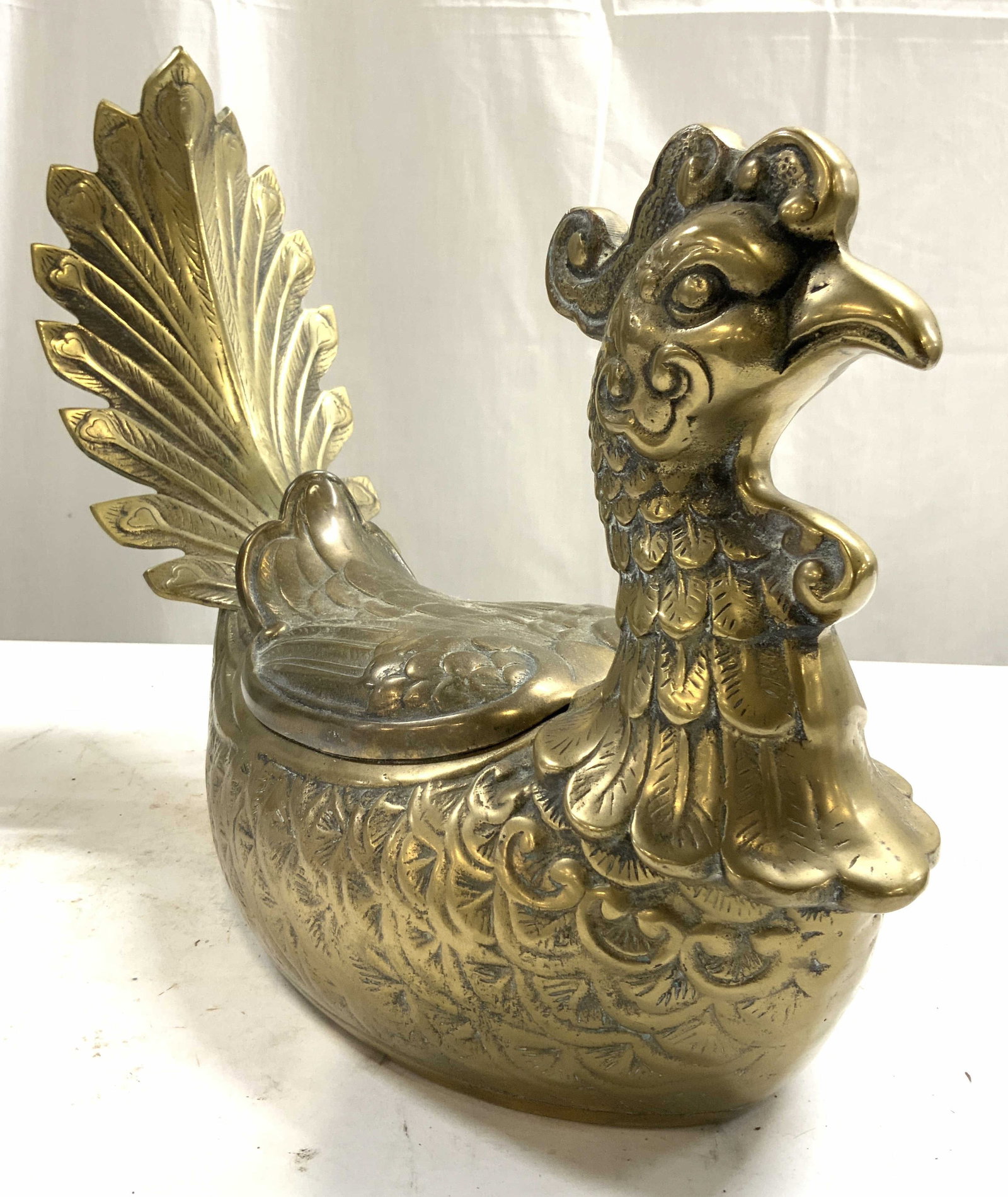 Vntg Asian Brass Pheasant Ornamental Box W Lid: Ornamental box is gold toned and brass. Piece has pheasant form. Box includes lid. Piece has intricate Relief to show facial and feather detail. Asian ornamental pheasant box. Piece measures approxima