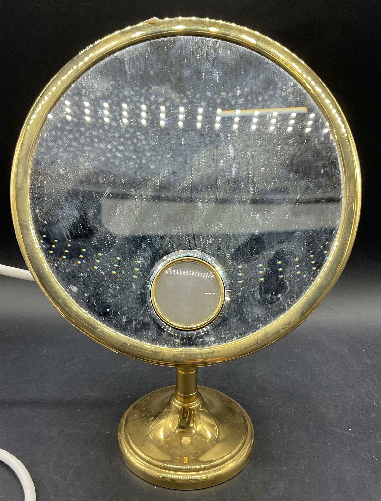 BROT FRANCE THE FRENCH REFLECTION Lighted Mirror: BROT FRANCE THE FRENCH REFLECTION Lighted Mirror. Crafted from polished gold tone metal and composite materials. Measures approx. 14H x 9.5W in. Adjustable. Corded. Not tested for function. Surface we