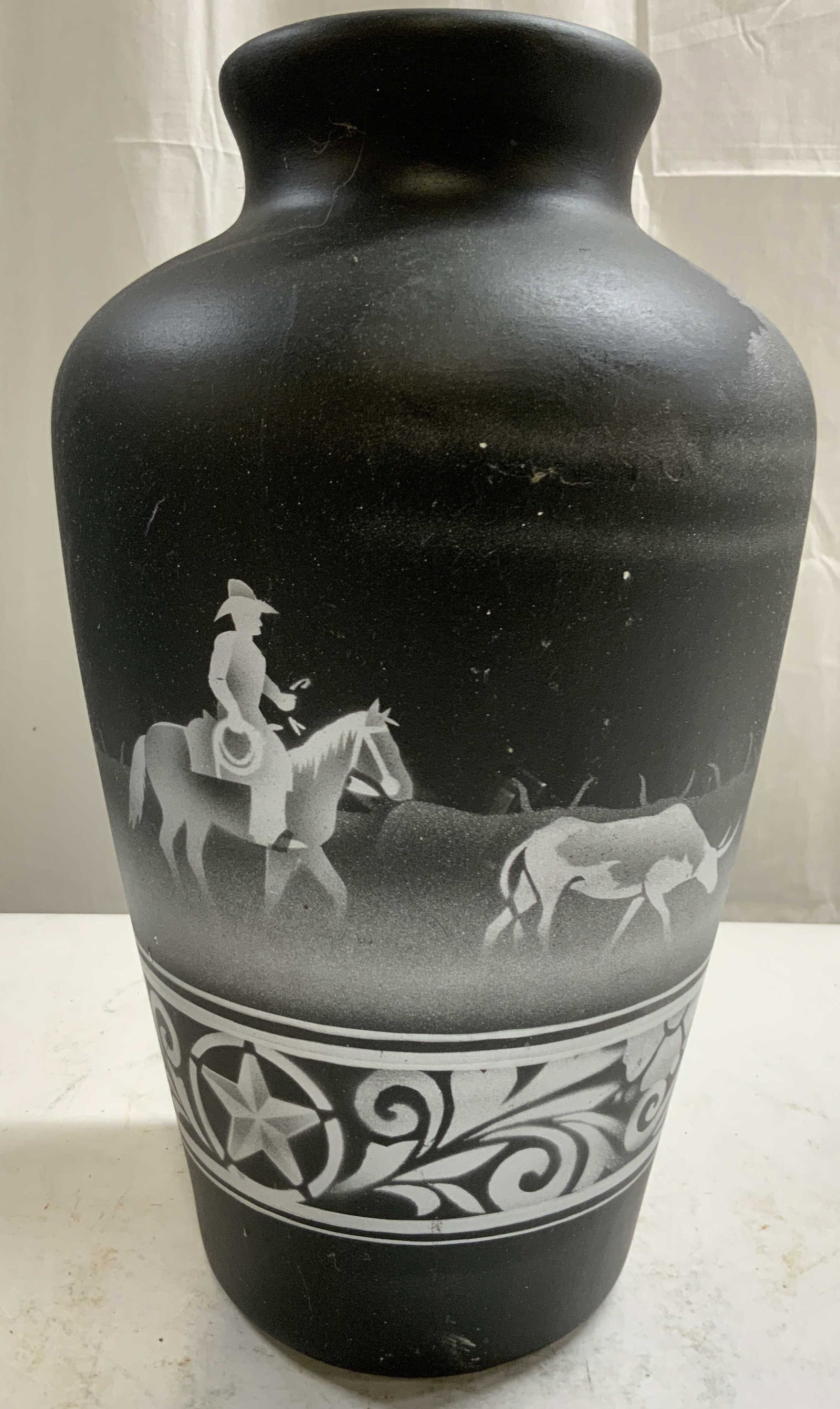 DINE Signed Vtg Native American Southwest Vase: Underside is signed DINE. Native American southwest pottery vase. Piece is black with silver toned depictions of a figure riding horseback following a steer. Vessel appears to be vintage. Piece measur