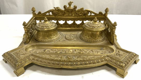Atq 19th C Ornate Brass Double Reservoir Inkwell: Inkwell is antique circa late 19th century. Piece is gold toned and brass with intricate ornate scroll, floral, leaf, figural and torch detail. Inkwell has double reservoir, each with hinged lids. Ink