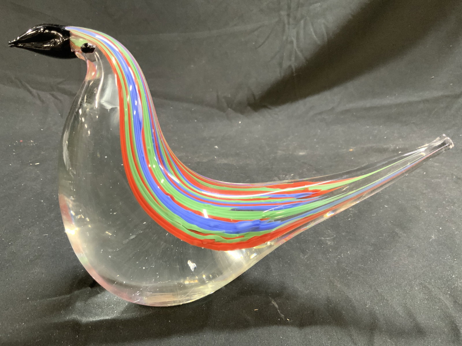 MURANO Art Gls Bird W Stripe Detail: Bird figure appears to be MURANO (No apparent markings). Piece is glass. Top of piece has red, green, & blue toned striped detail. Beak is black toned. Art glass bird measures approximately 5.75 inche
