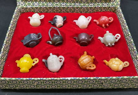 Set 12 Mini Assorted Jade Stone Tea Pots: Set 12 mini assorted Jade stone tea pots. Various tea pot shapes and designs, various colors. Comes in velvet padded box. Asian characters present on each pot. Removable lids. Box measures 11.5 x. 8.5