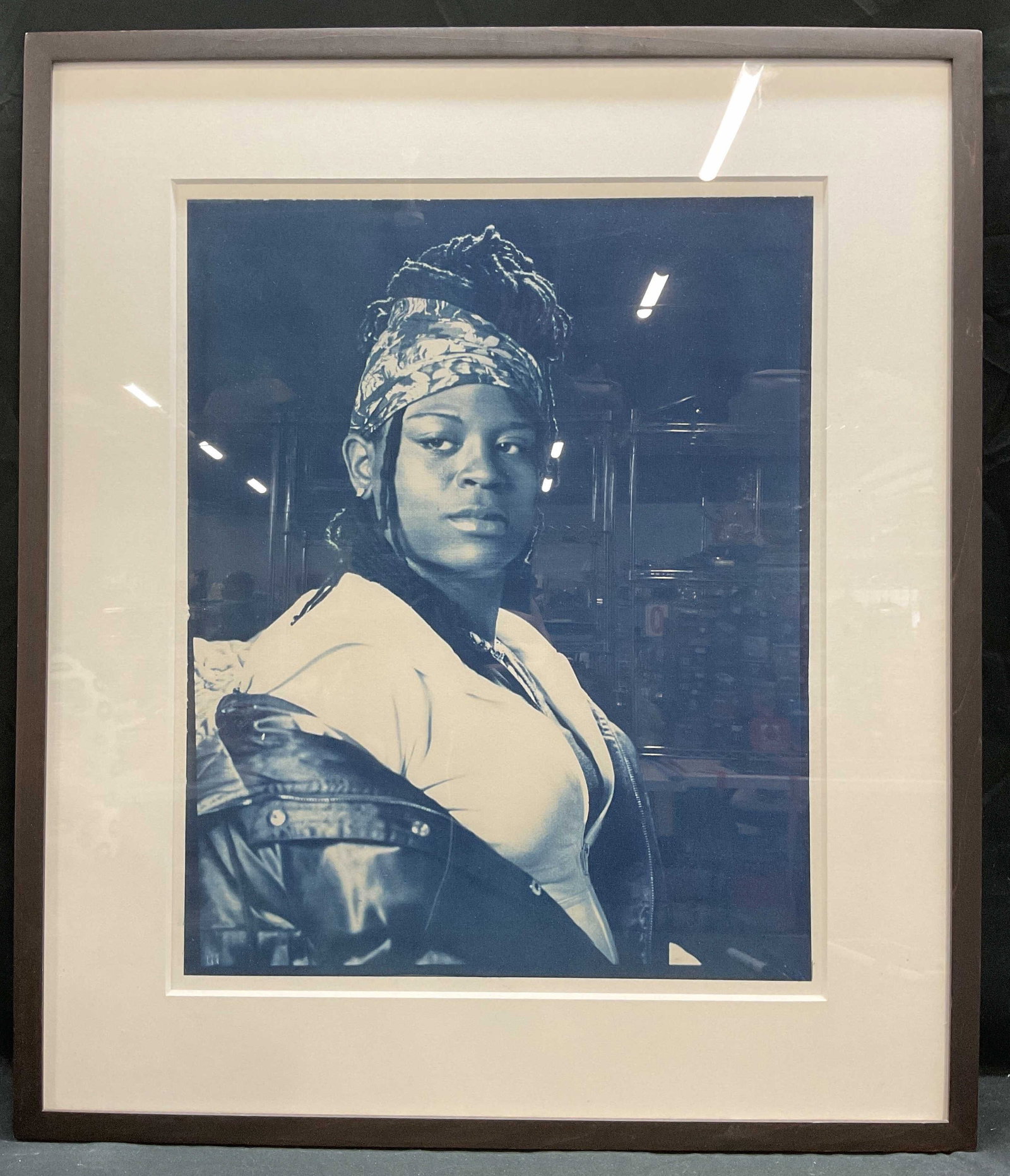 Framed Josh Lehrer African Queen Cyanotype: Framed and matted cyanotype print on watercolor paper. African Queen by Josh Lehrer. Image a woman wearing jacket. Robert Miller Gallery label on verso. Artwork measures 25 x 19 inches. Black wood fra