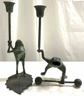 Lot 2 Vntg Verdigris Patina Frog Candlesticks: Lot includes 2 candlesticks, each have verdigris patina finish. Depicts 1 frog lifting a weight & 1 frog standing on a leaf holding candlestick up. Candlesticks are vintage. Largest candlestick measur