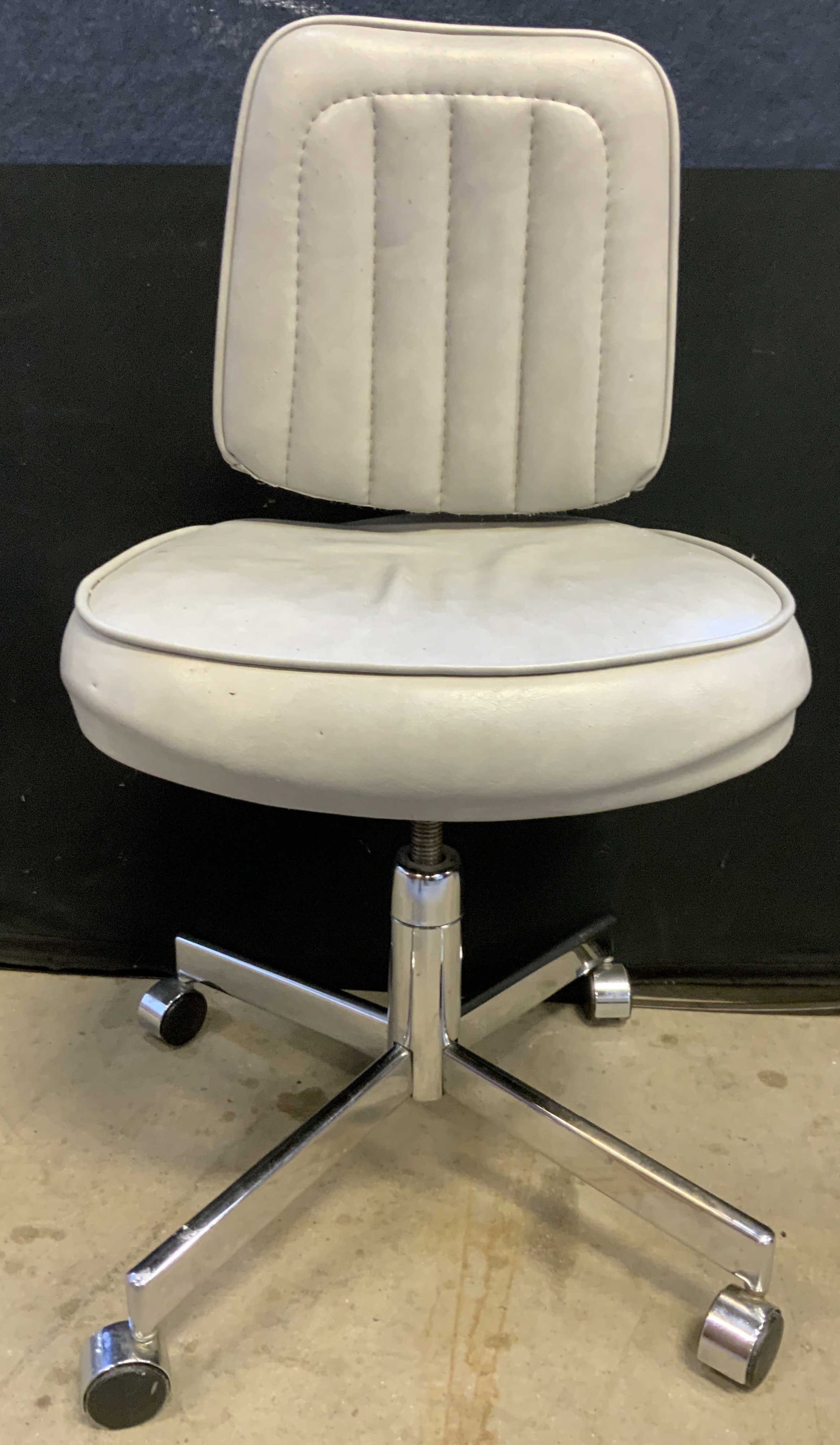 GALAXY OFFICE FURN Vntg Office Chair Slate: Underside reads GALAXY OFFICE FURNITURE. Piece is upholstered in light slate toned leather. Office chair sits on 4 wheels. Chair Measures approximately 33 inches tall 20 inches wide at base 21 inch se