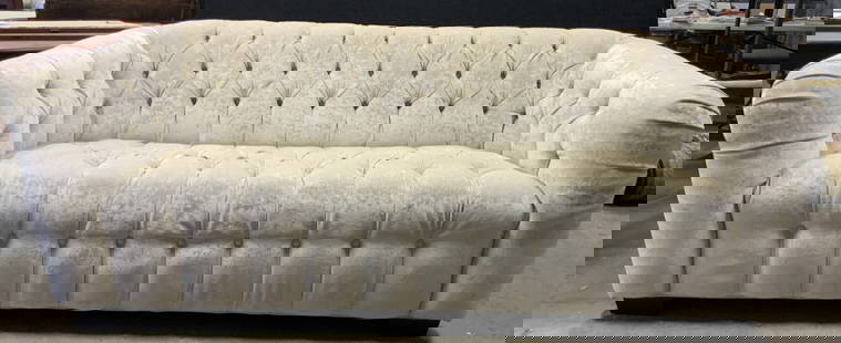 MITCHELL GOLD BOB WILLIAMS Tufted Sofa: Tag on underside reads MITCHELL GOLD BOB WILLIAMS. Sofa is upholstery in white gold toned fabric with tufted detail. Loveseat has black toned feet, appear to be wooden. Measures approx 86 inches long