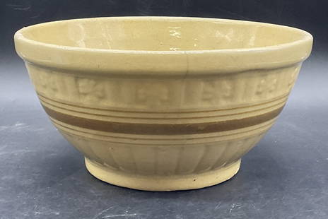 Vintage Banded Yellowware Pottery Bowl: Vintage Banded Yellowware Pottery Bowl. Yellow and brown hues to the piece. Impressed floral and ribbed details to the piece. Measures approx. 4.5H x 9W in. Cracking, crazing, discoloration, and chipp