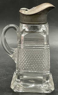 Vintage Cut Glass & Metal Syrup Dispenser Pitcher: Vintage Blown Cut Glass & Metal Syrup Dispenser / Pitcher. Silver tone hinged metal lid. Measures approx. 6H x 3.75W in. Measured at widest point. Pontil to the underside. Imperfections to the metal.