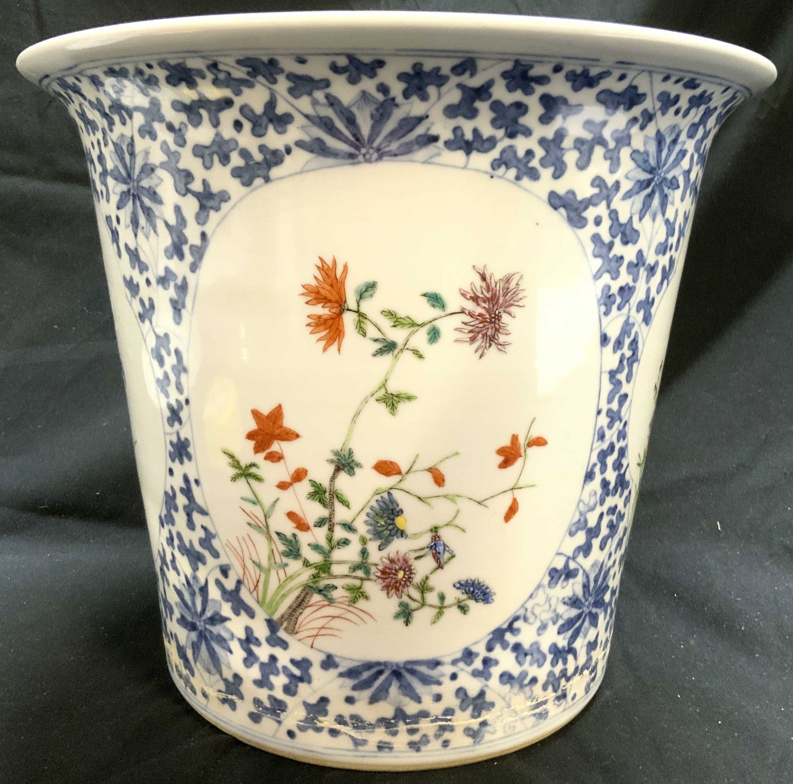 Vtg H Painted Asian Porc Planter W Floral Detail: Planter is hand painted and porcelain. Piece has multi toned floral leaf and vine detail. Rim is also detailed. Underside has drainage hole. Vessel rim leans outward 11 inches tall 13 inches wide. Pla