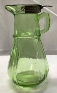 Vintage Green Uranium Glass Pitcher: Vintage Green Uranium Glass Syrup Pitcher Syrup pitcher with a metal lid. Pitcher is green uranium & has a small handle. Surface wear consistent to age, use & exposure. Measurements: length 3.6in x wi