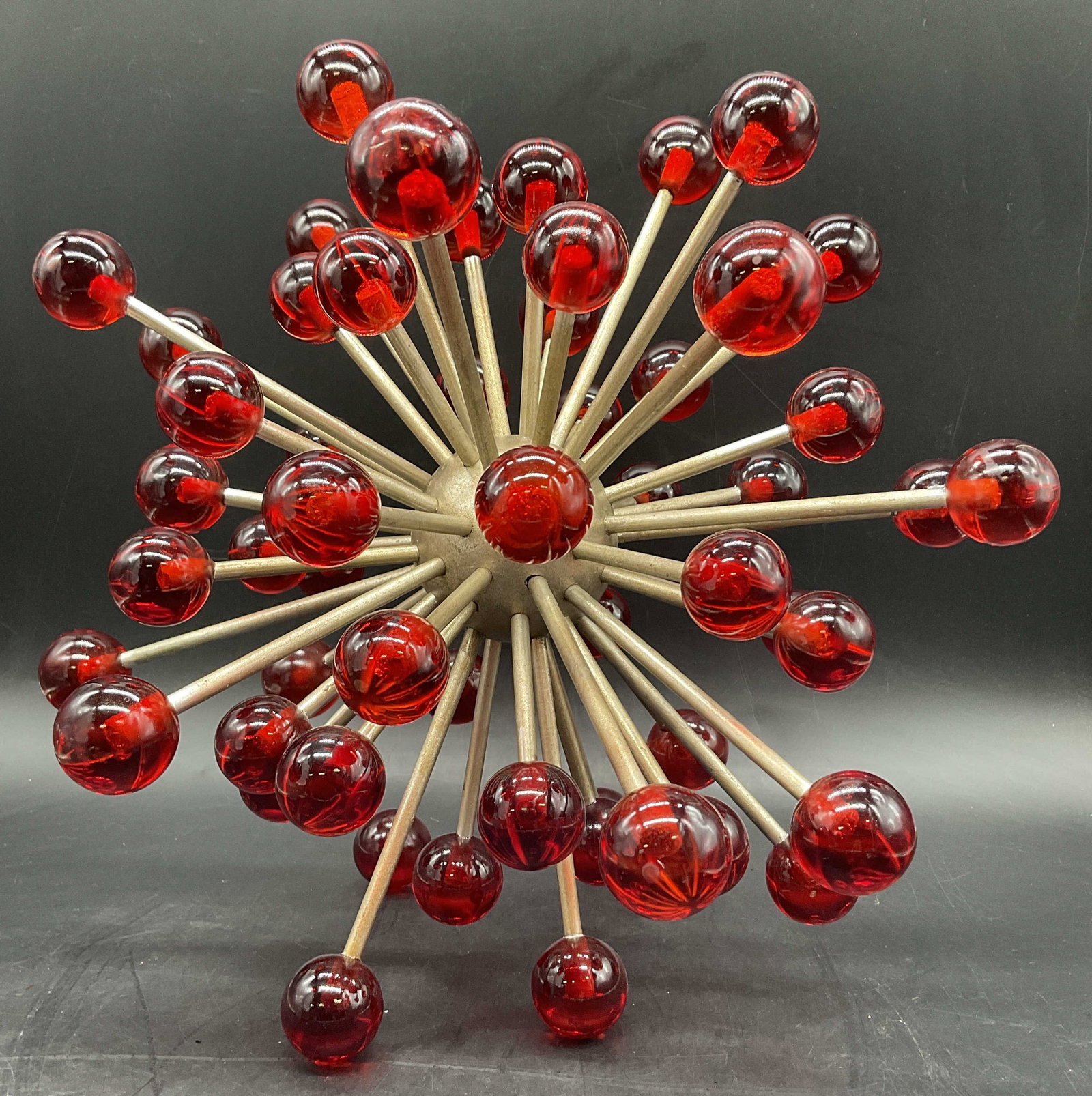 Vintage Sputnik Style Red Lucite & Metal Sunburst: Vintage Sputnik Style Red Lucite & Metal Sunburst Sculpture. Some variations in color to the red lucite orbs. Measures approx. 12.25H x 13.25W in. Discoloration and surface wear present. home decor, h