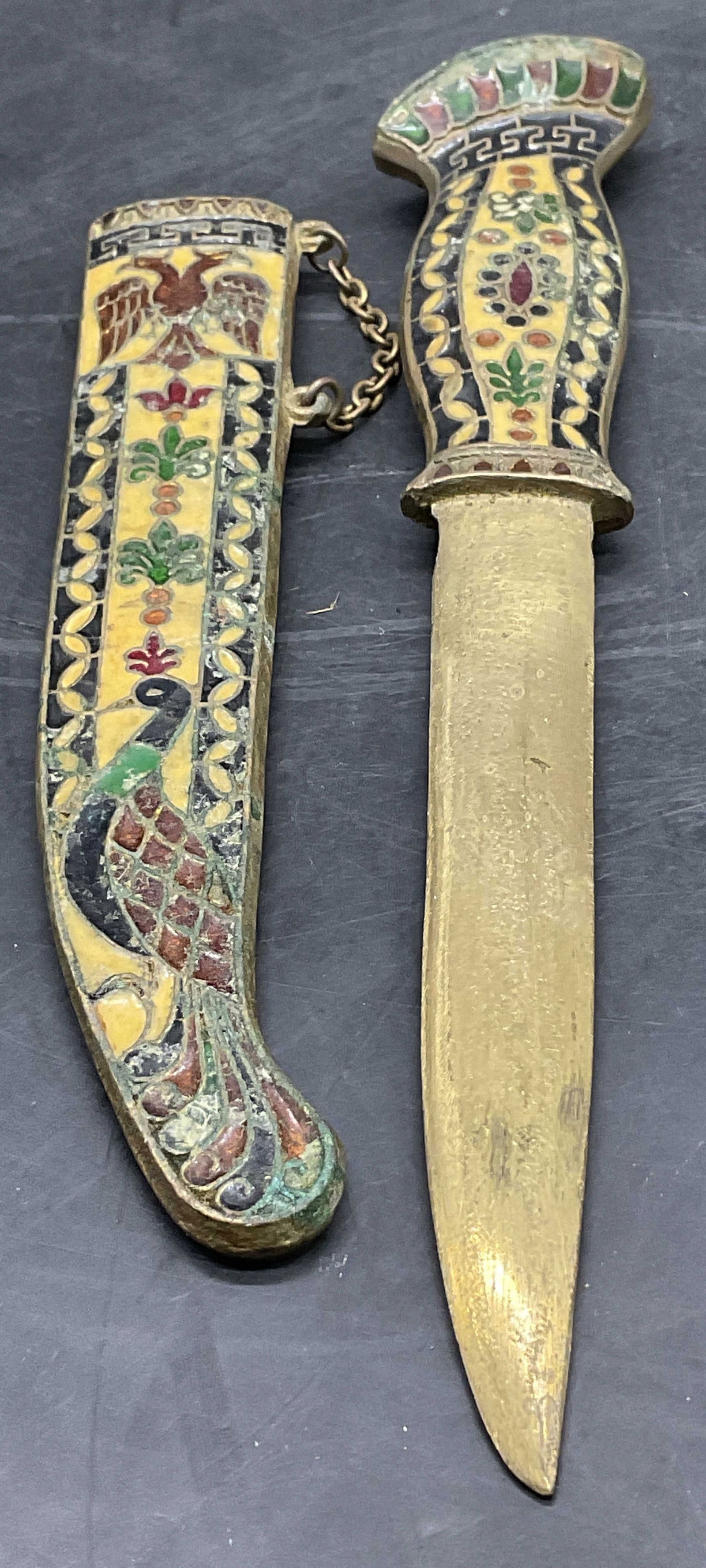 Vintage Enameled Brass Letter Opener W/ Sheath: Vintage Enameled Brass Letter Opener With Sheath. Multicolored hues to the handle and sheath. Decorated with peacocks, mythological creatures, florals, and geometric patterns. Measures approx. 10.5L x