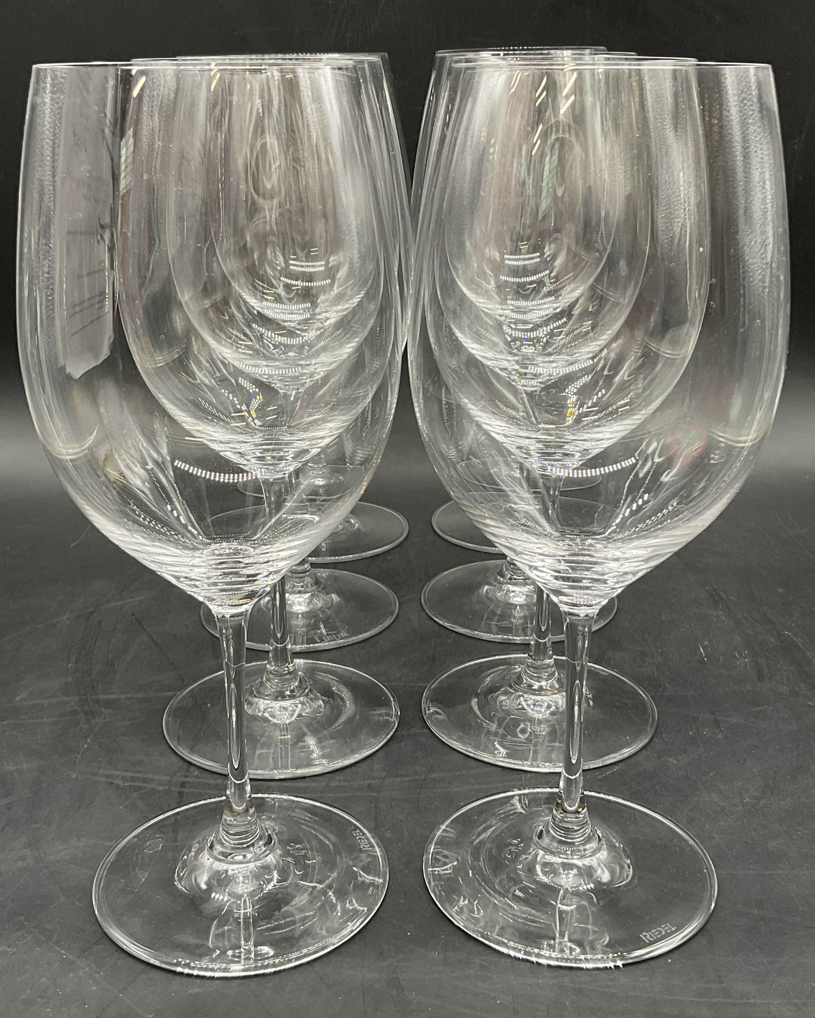 Set 8 RIEDEL Crystal Wine Glasses, Stemware: Eight RIEDEL Colorless Crystal Wine Glasses. Measures approx. 9H x 3W in. Width measured at the mouth of the glass. Undersides signed RIEDEL. Surface wear consistent with age, use, and exposure. home