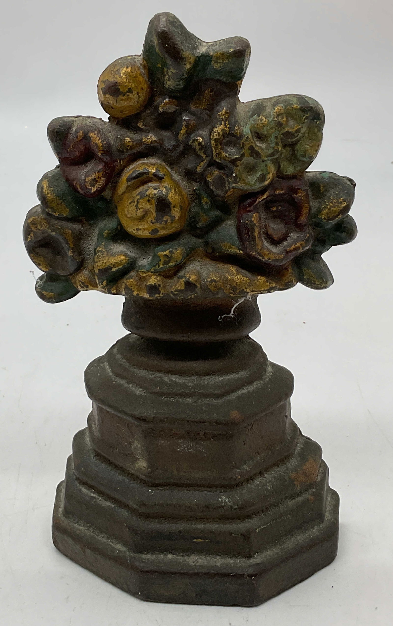 Antiq Brass Bronze Floral Bouquet Door Stopper: Antique brass bronze floral bouquet door stopper. Flower bouquet design pedestal door stop. 7 x 4 x 2.5 inches. Weighs 2lb 9oz. Some surface wear including discoloration, loss in color, and residue pr