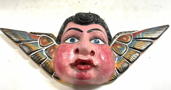 H Painted Wood Angelito Cacheton Mex Flk Art: Wall hanging is hand painted & lightweight wood. Angelito Cacheton Mexican Folk Art wall decor. Depicts a male head figure with multi toned wings. Piece measures approximately 18 inches wide 7 inches
