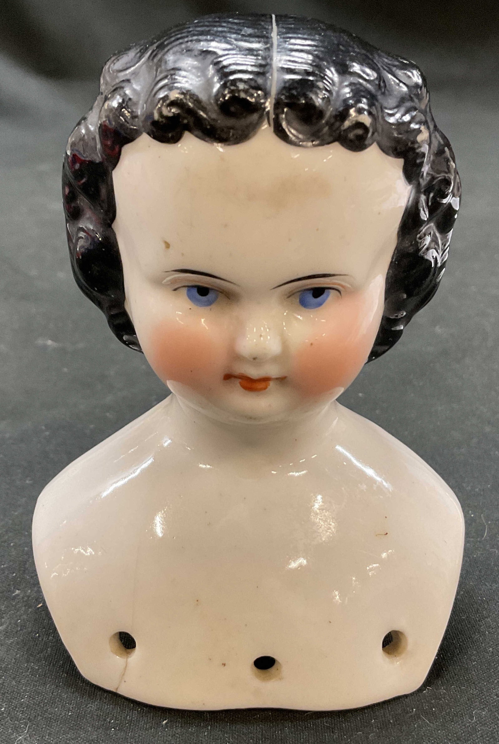 Antiq Porcelain Woman Figure Doll Head: Antique porcelain a woman figure doll head. Pale woman with blue eyes and black curly hair doll head. 2.75 x 4 x 2 inches. Slight loss in color and residue present. Doll head, porcelain doll, collecti